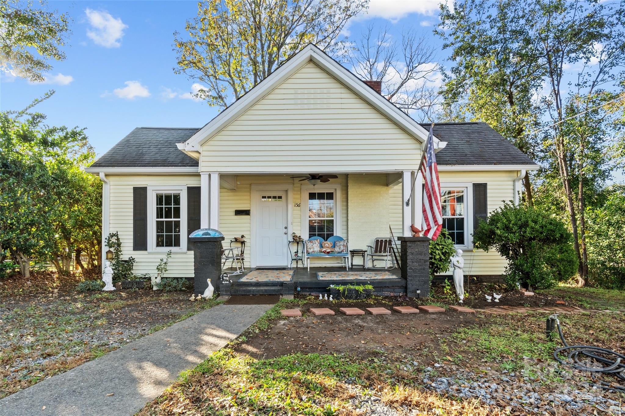 a front view of house with yard outdoor seating and barbeque oven