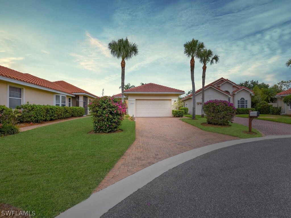 a front view of a house with a garden and yard