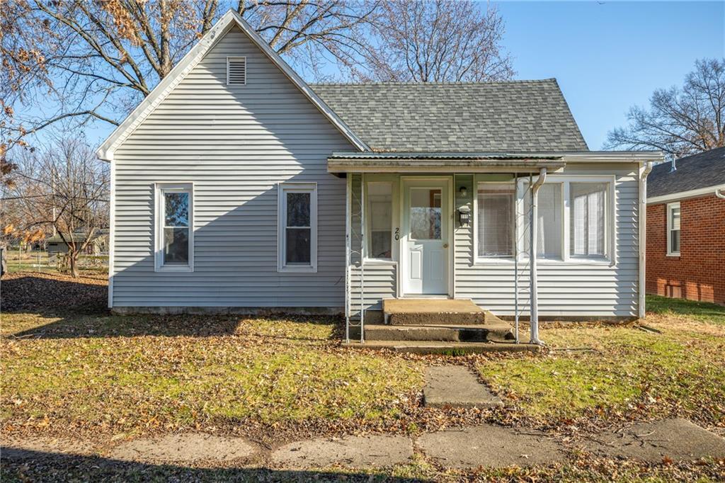 a view of a house with a yard and wooden fence