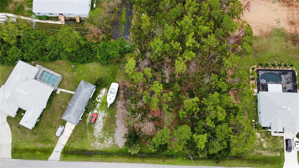 an aerial view of a house with a yard basket ball court and outdoor seating