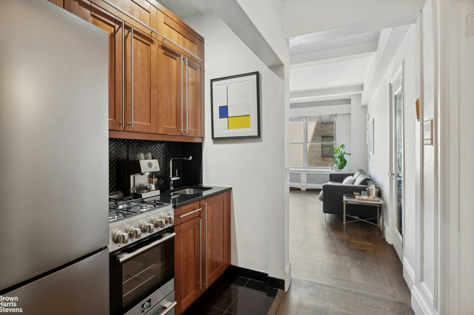 a kitchen with stainless steel appliances granite countertop a stove and a refrigerator