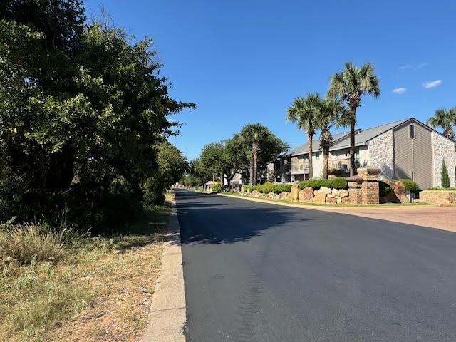 a view of street with large trees