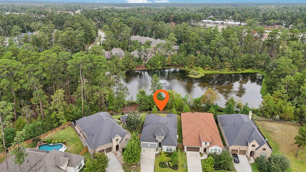 an aerial view of house with yard and lake view