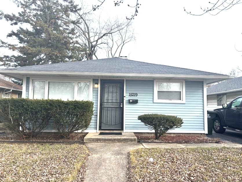 a front view of a house with a yard and glass windows