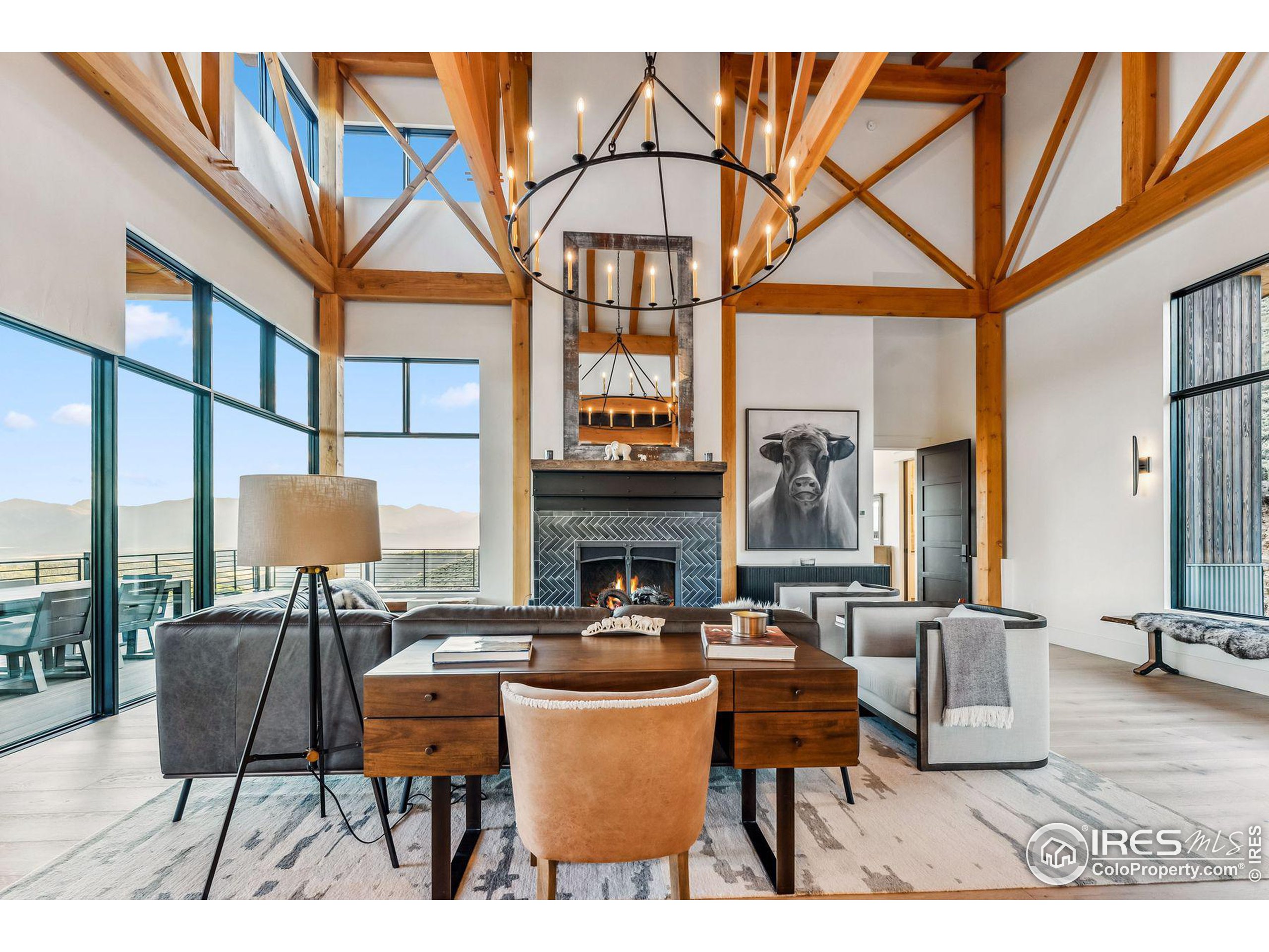 a living room with fireplace furniture and a large window