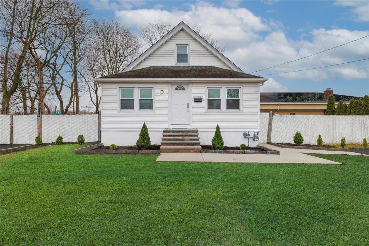 a front view of house with yard and green space