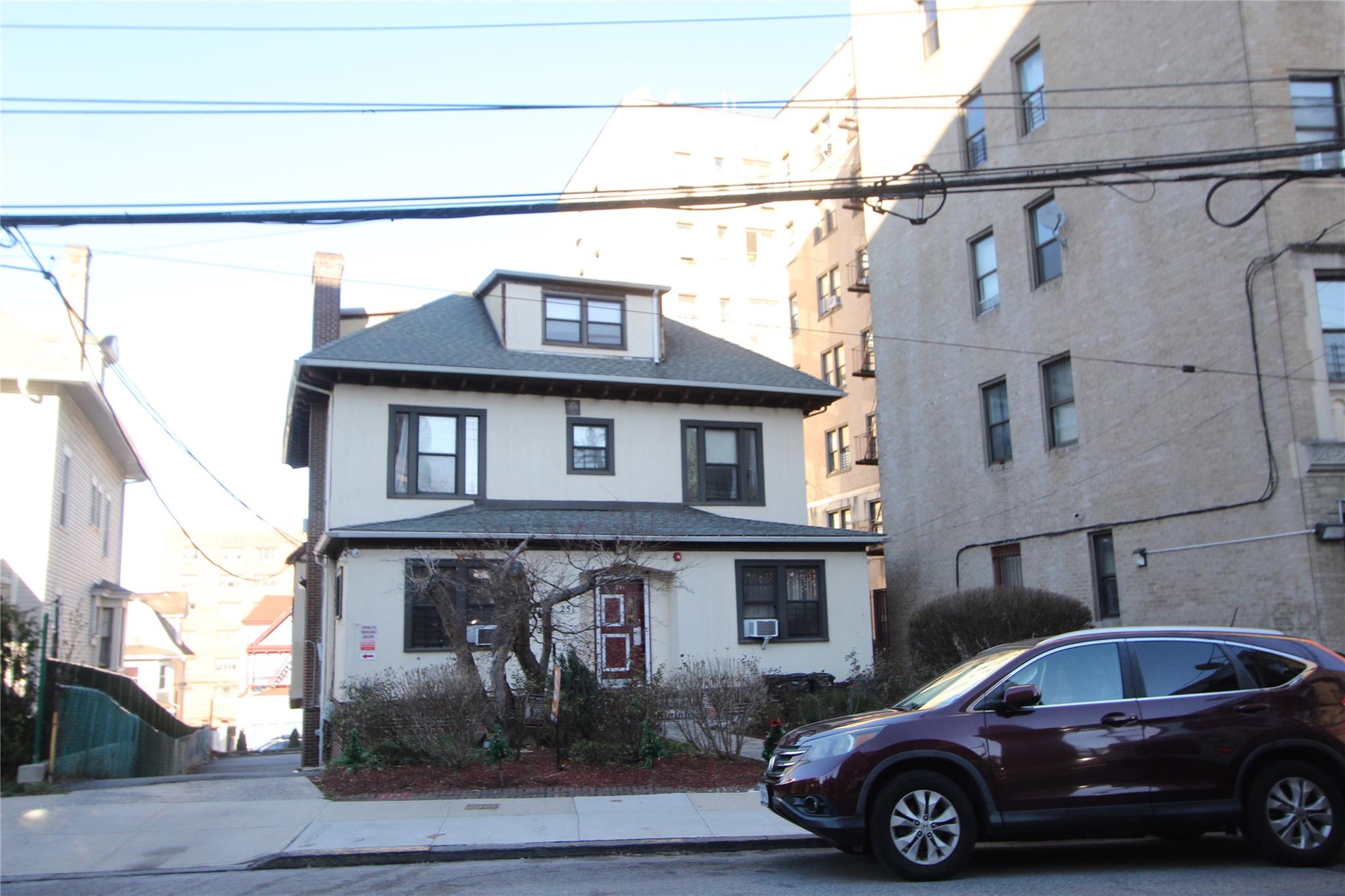 a front view of a house with parking space