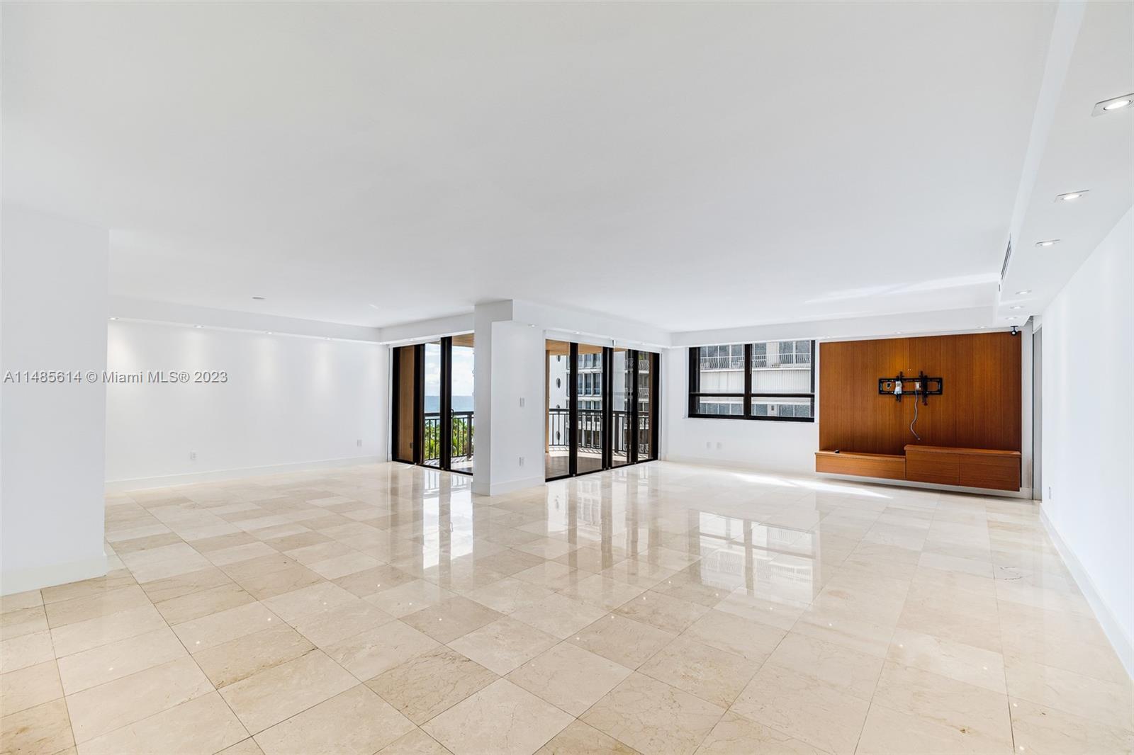 a view of an empty room with window and fireplace