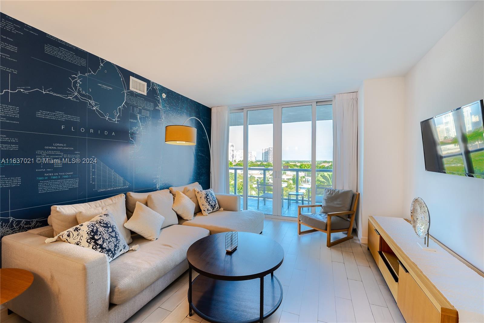 a living room with furniture and a floor to ceiling window