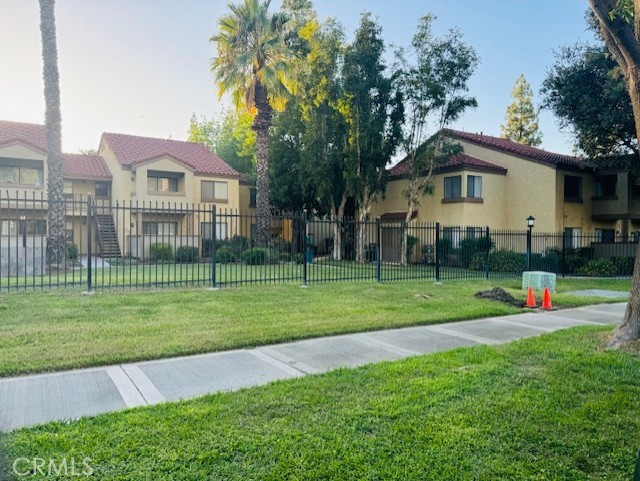 a front view of a house with a yard and trees