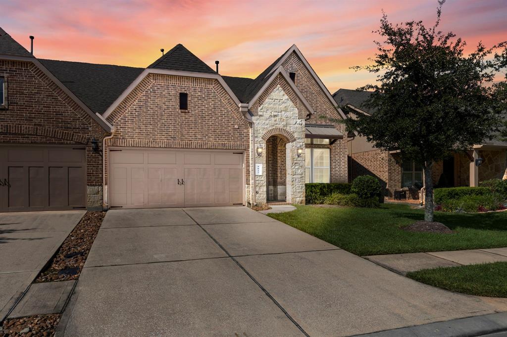 Welcome to The Fountains at Jacobs Reserve, a gated community you'll be proud to call home! This beautifully maintained townhome boasts an elegant brick and stone exterior with two-car attached garage.