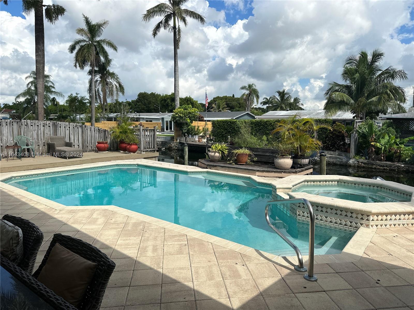 a view of swimming pool with chairs