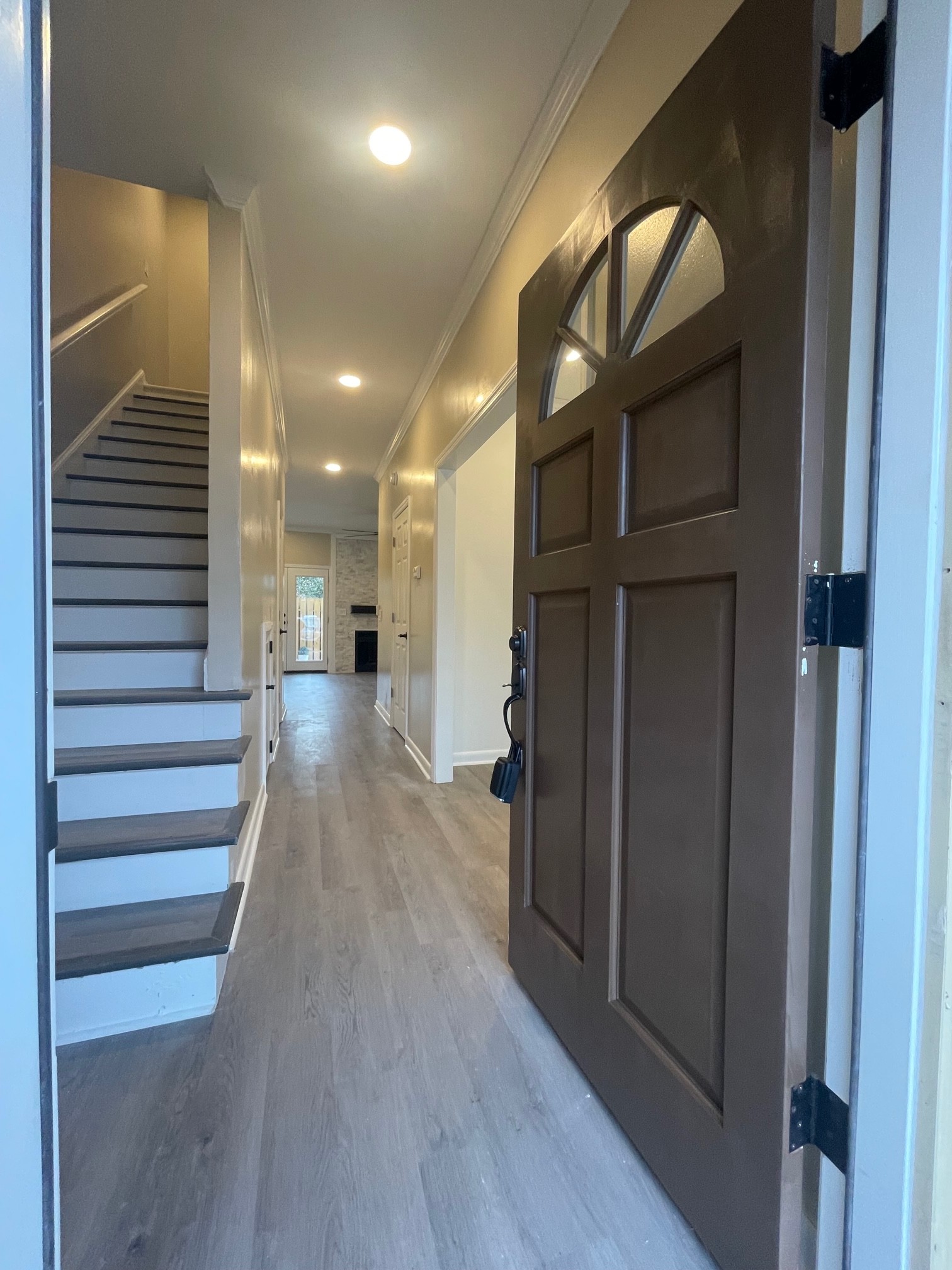 a view of a hallway with wooden floor and staircase