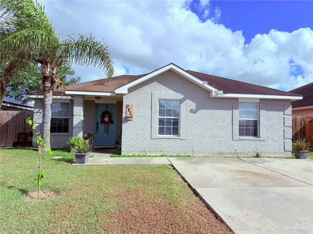 Single story home with a front lawn