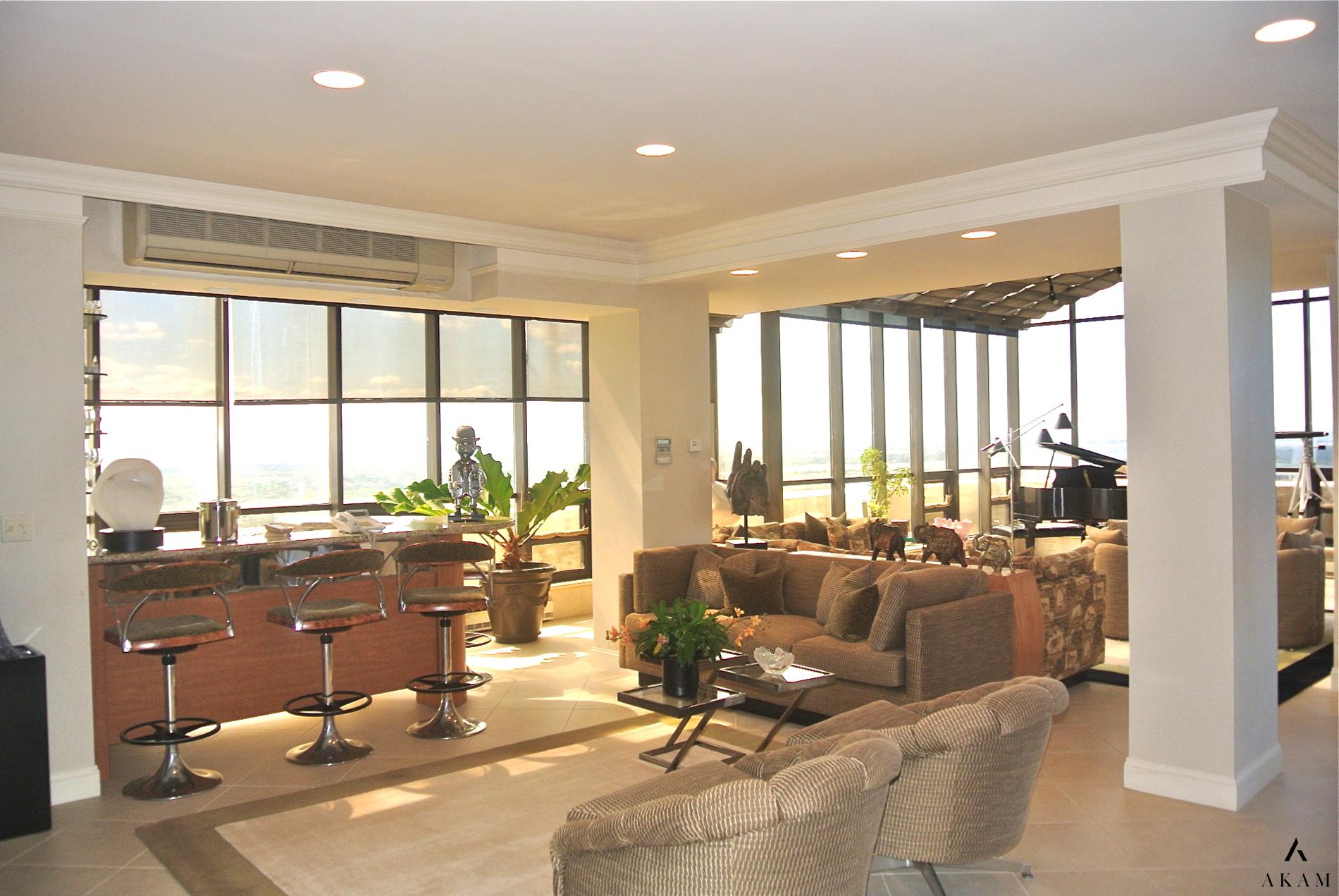 a living room with furniture and floor to ceiling window