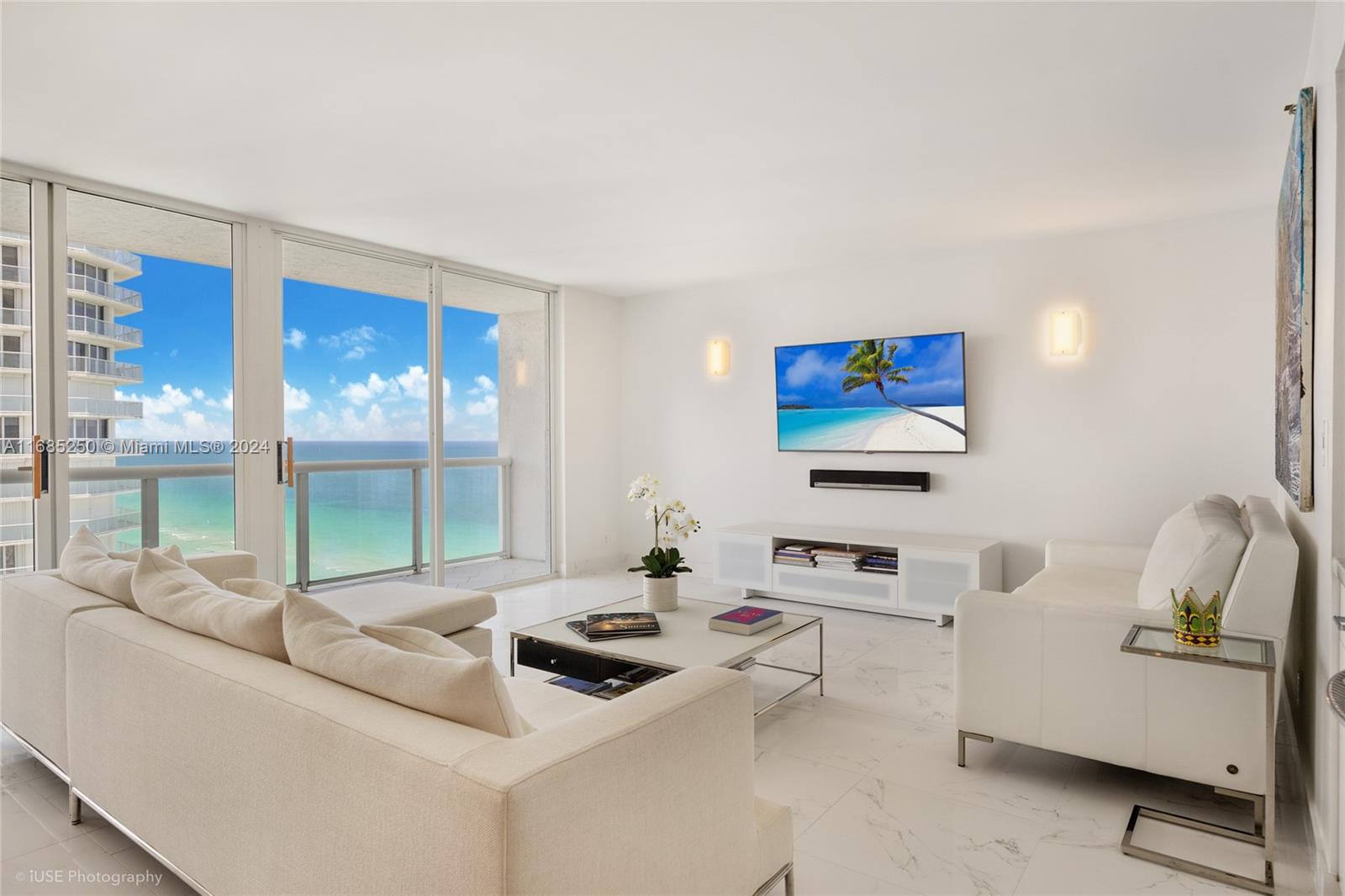 a living room with furniture and a floor to ceiling window