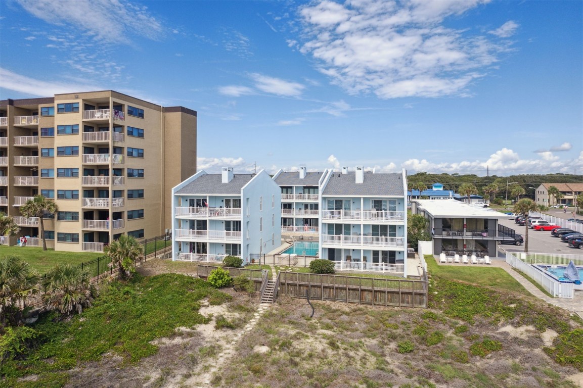 a front view of a building with a garden