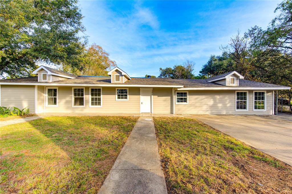 front view of a house next to a yard