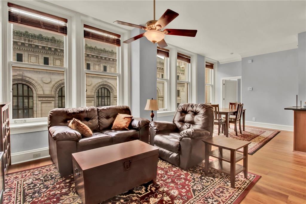 a living room with furniture ceiling fan and a rug