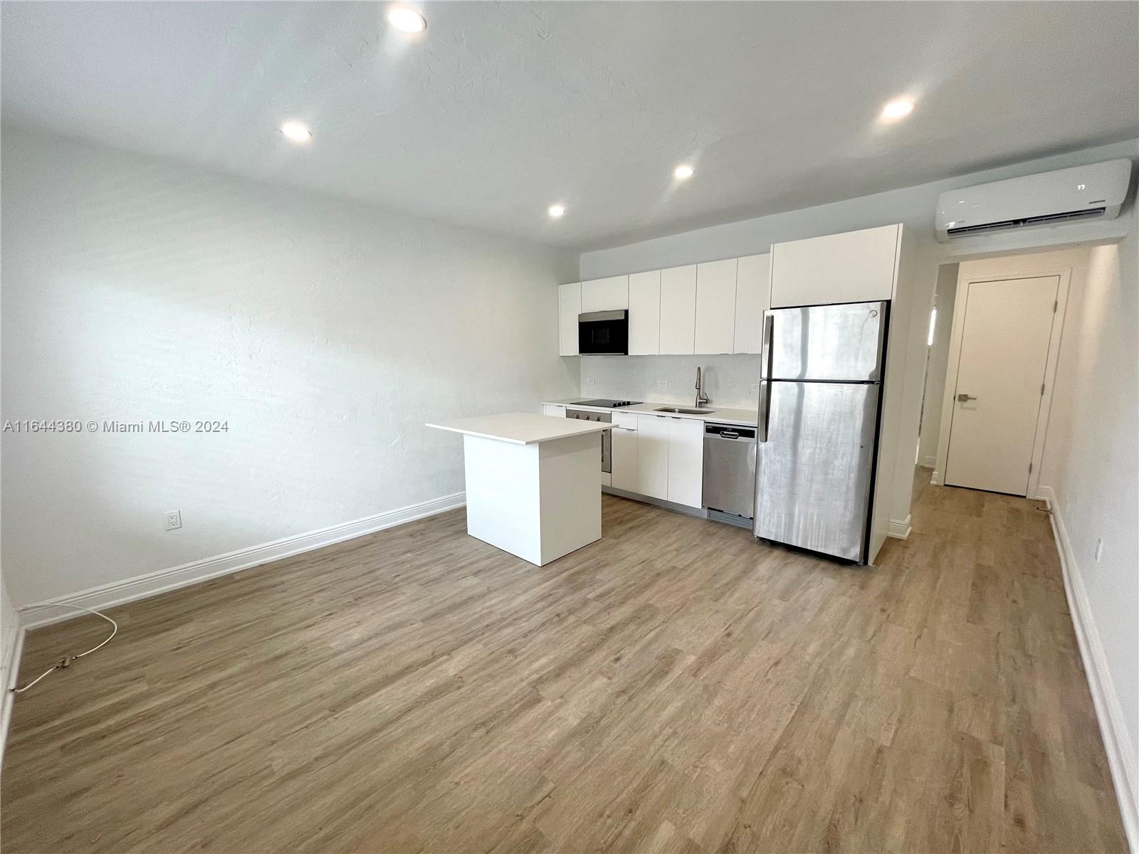 a kitchen with stainless steel appliances a refrigerator sink and microwave