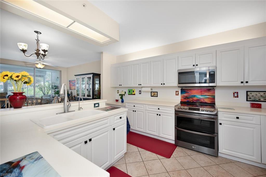 a kitchen with stainless steel appliances and white cabinets