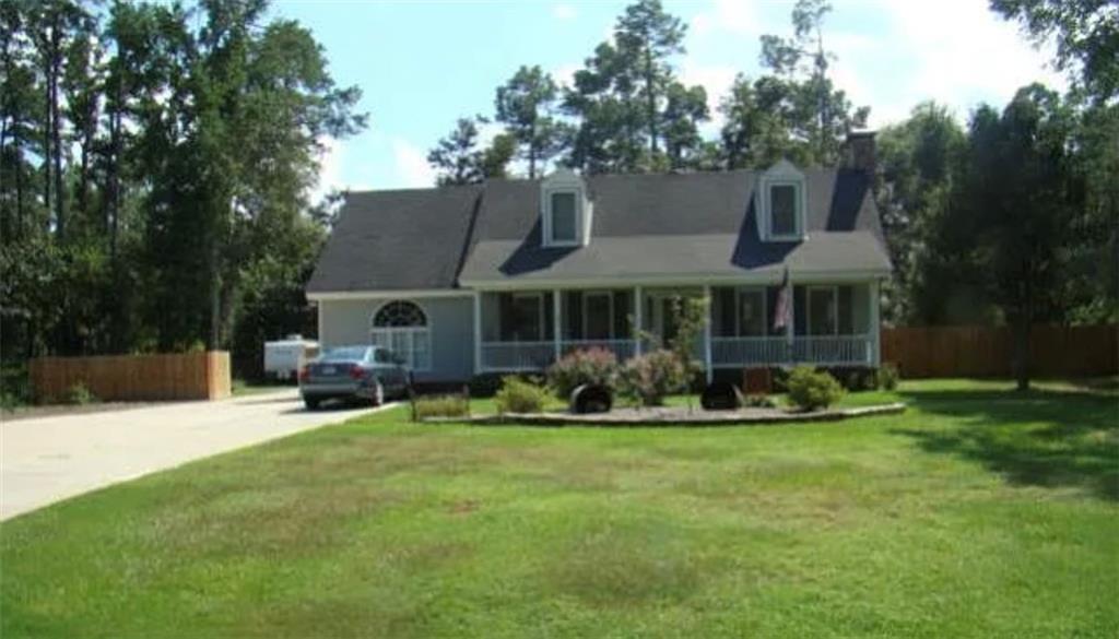 a front view of a house with sitting area and garden