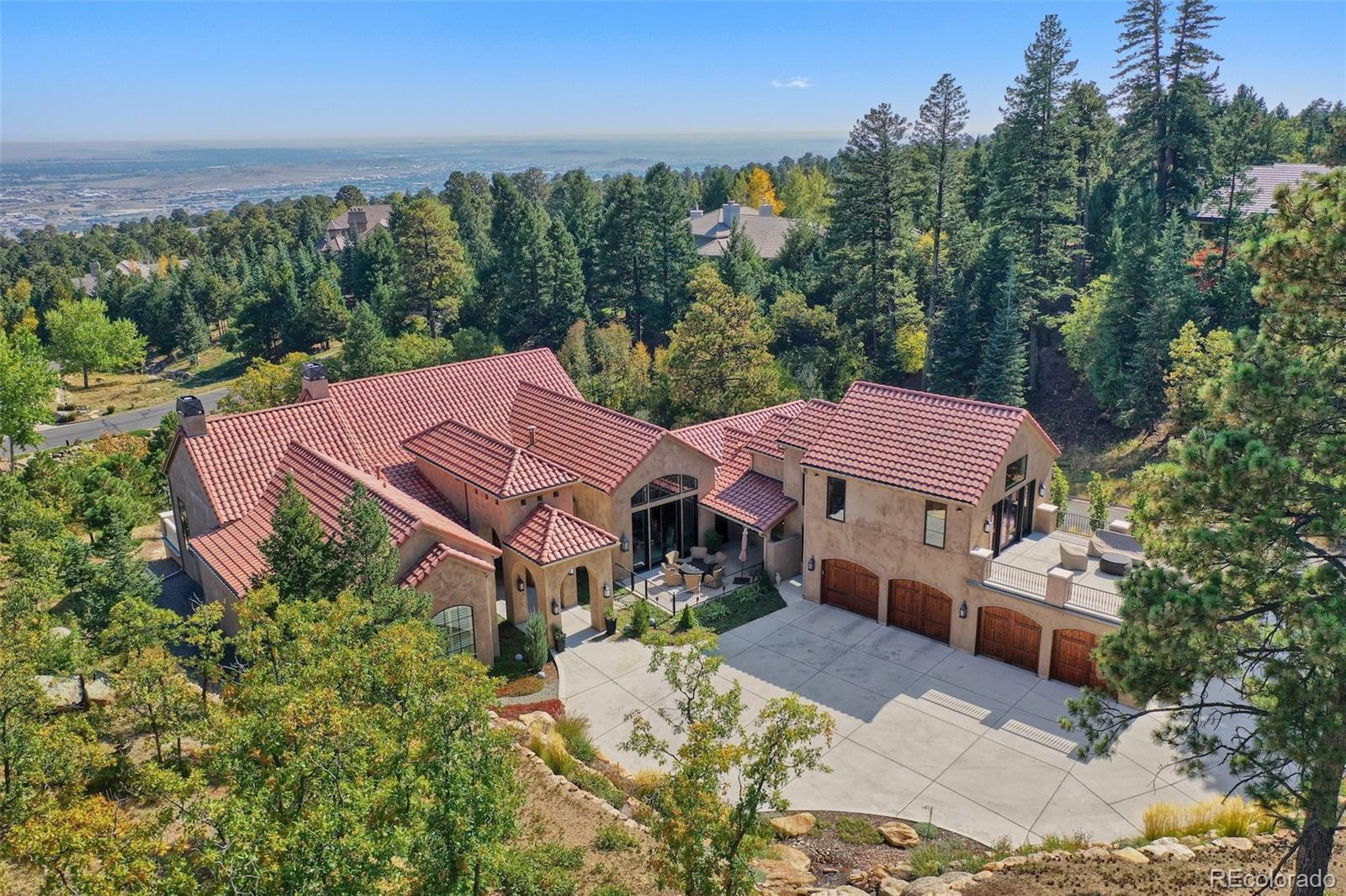 an aerial view of house with yard and mountain view in back