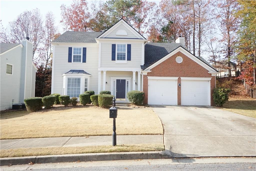 a front view of a house with a yard