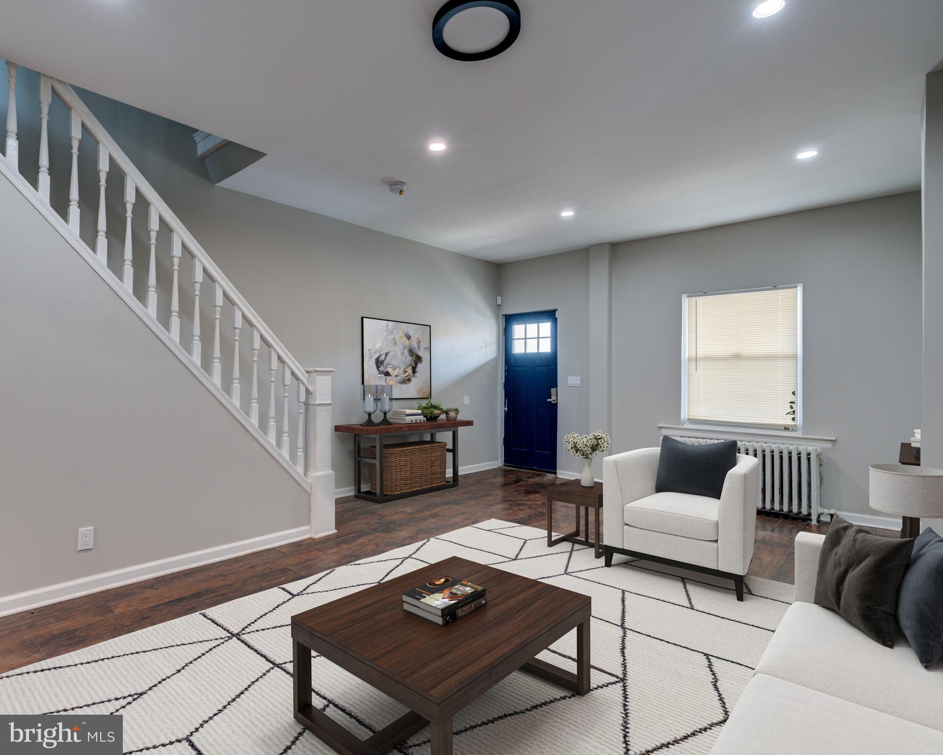 a living room with furniture and wooden floor