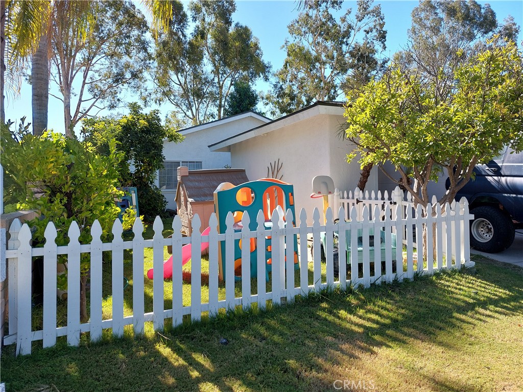 a view of small yard with wooden fence