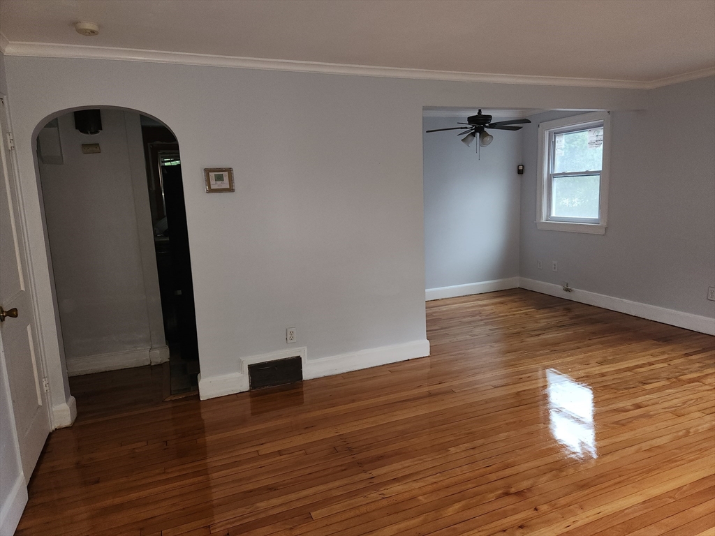 wooden floor in an empty room with a window