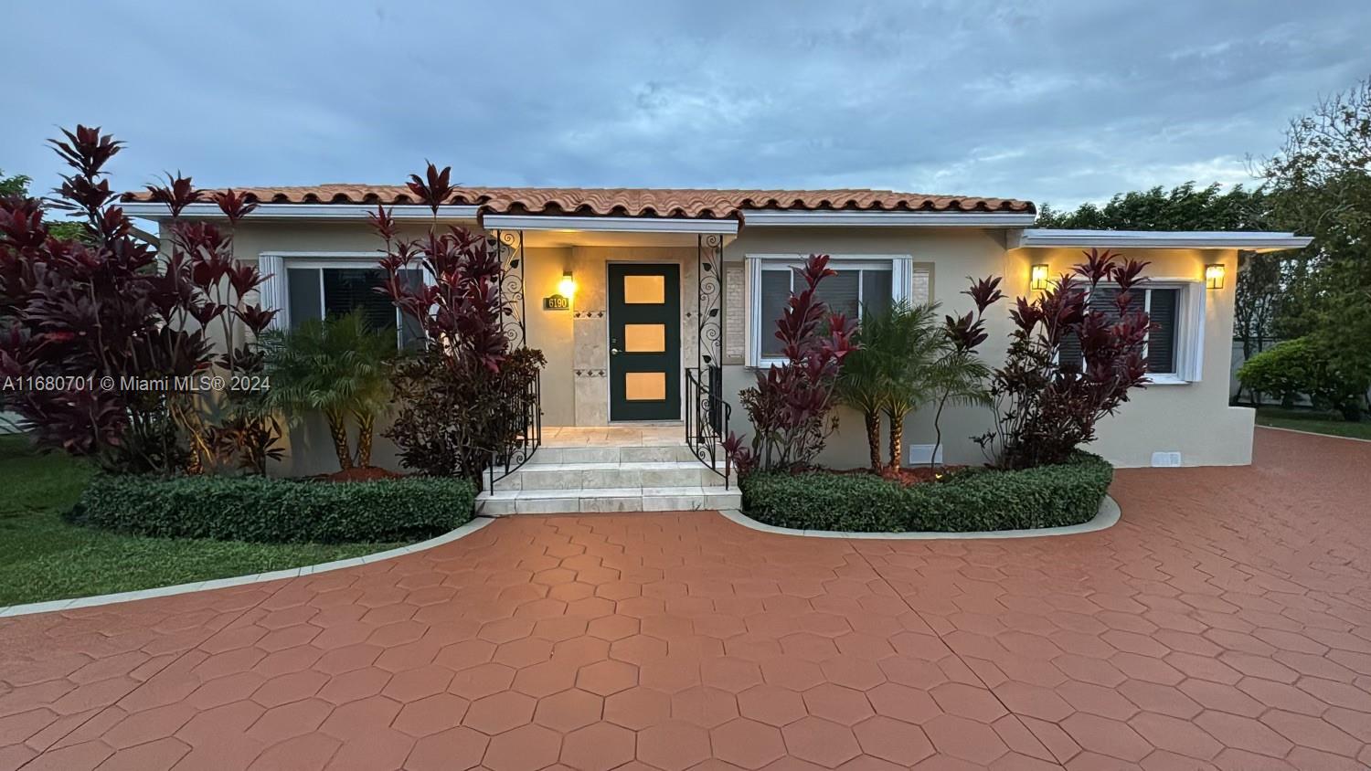 a front view of a house with garden