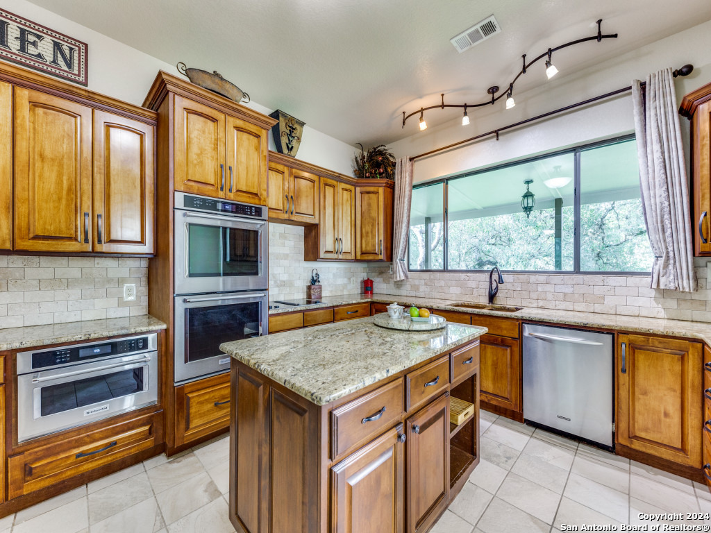 a kitchen with a stove sink and microwave