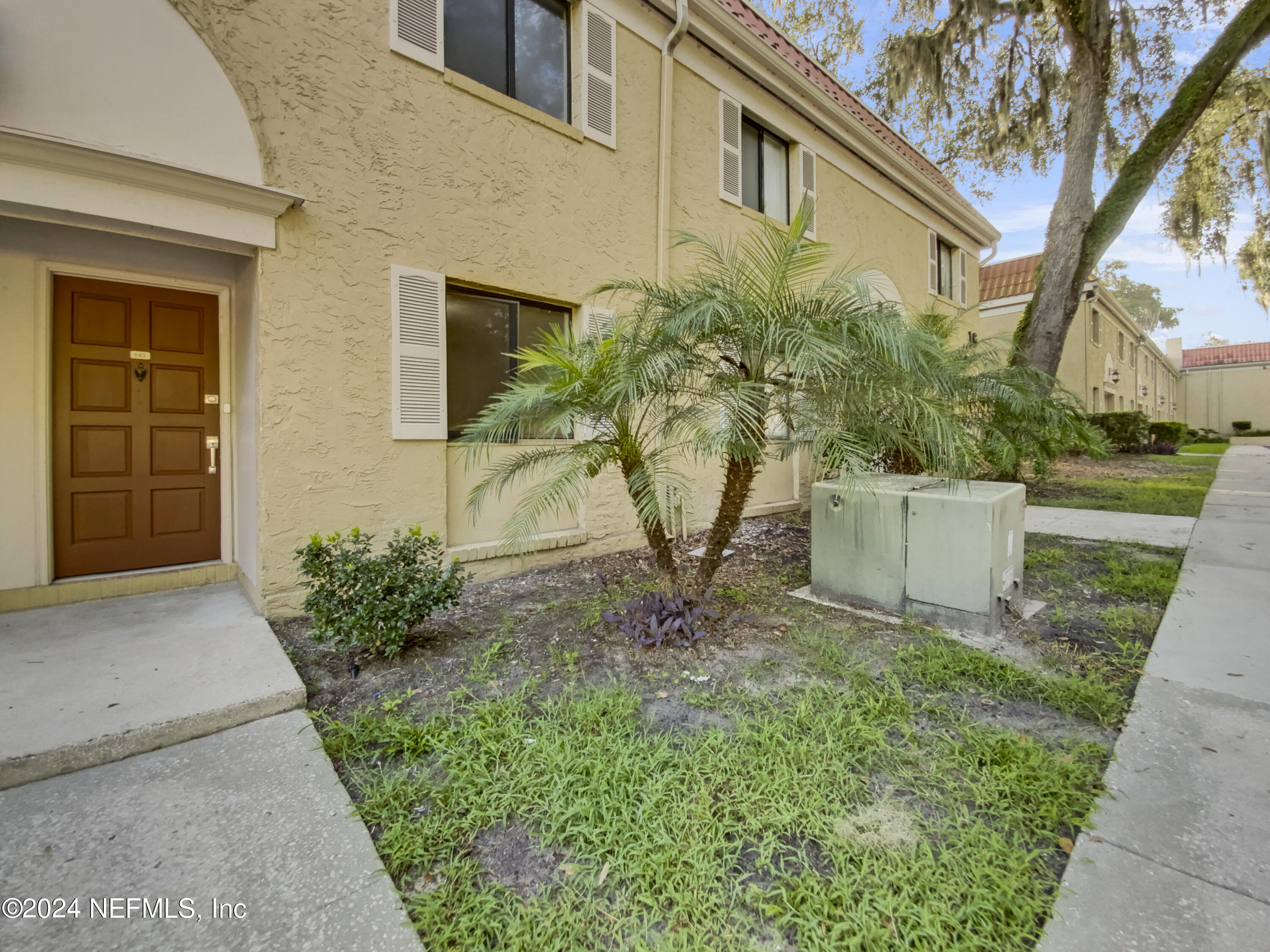 a house that has a tree in front of the house