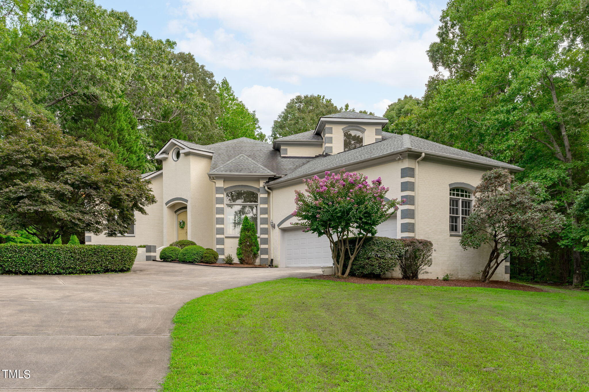 a front view of a house with a garden