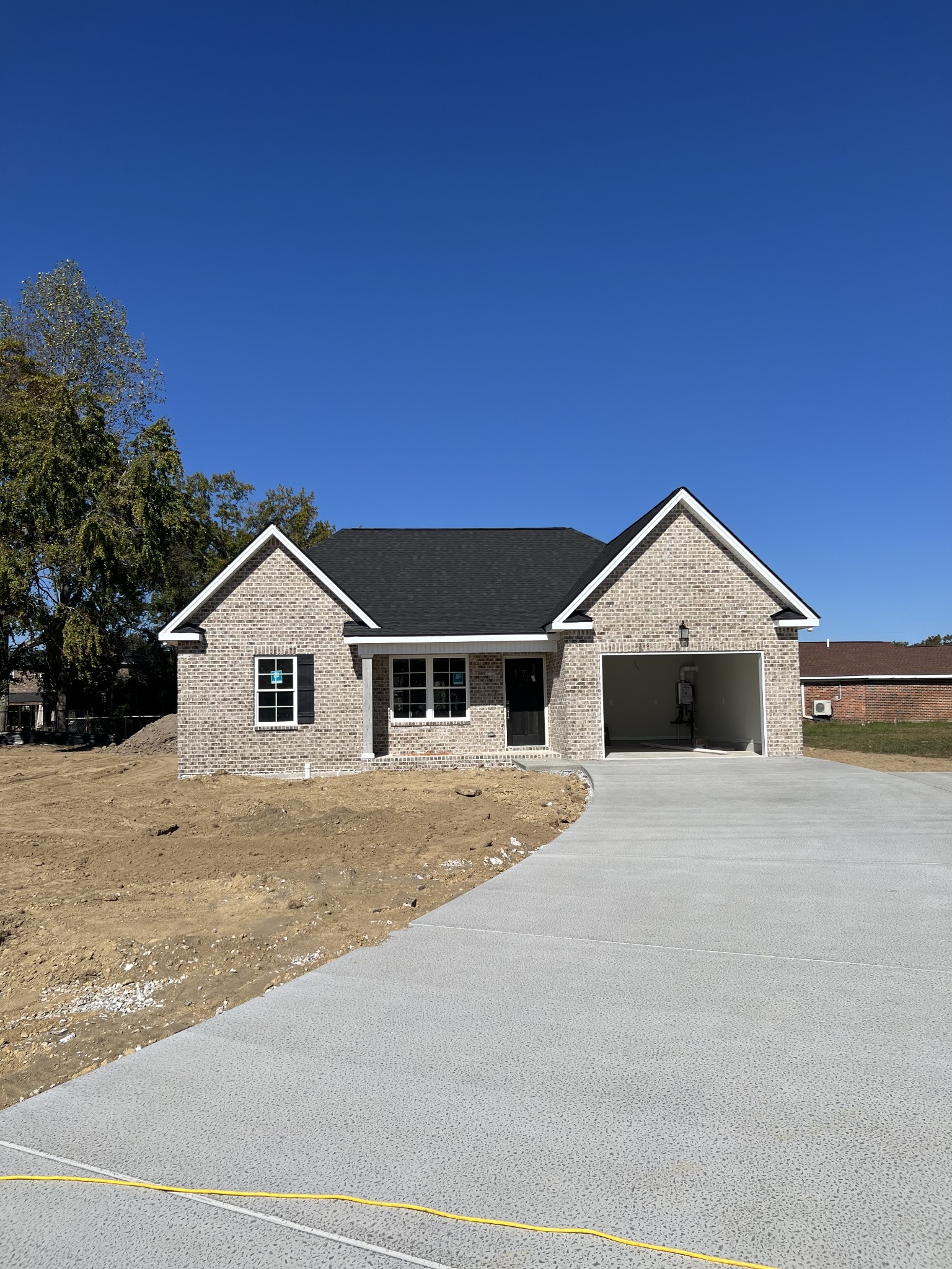 a big house with a yard and large trees