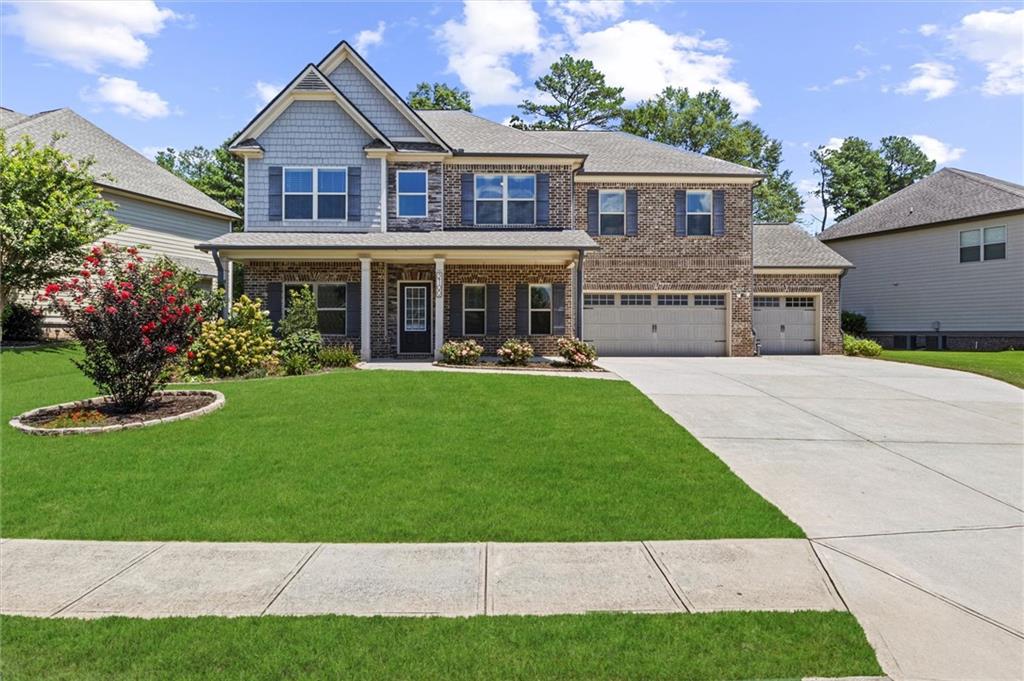 a front view of house with yard and green space