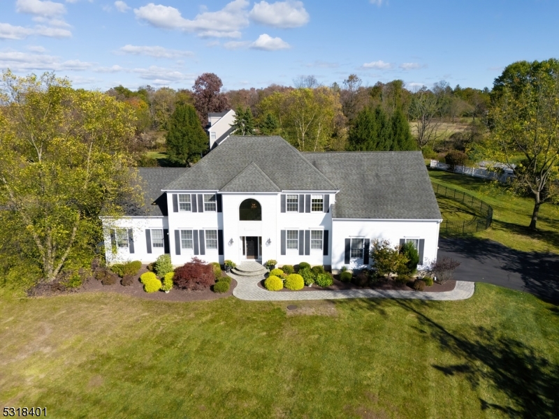 a aerial view of a house with swimming pool garden and patio