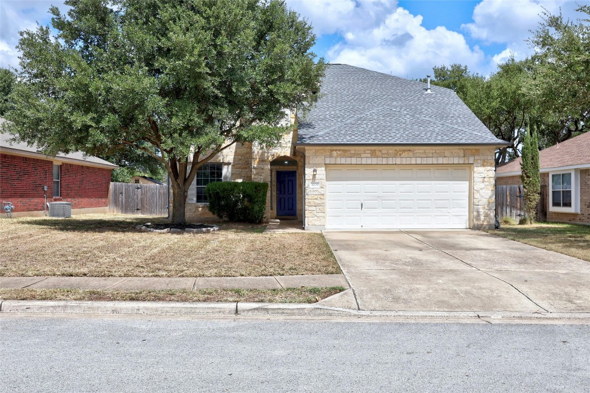 a front view of a house with a yard and garage