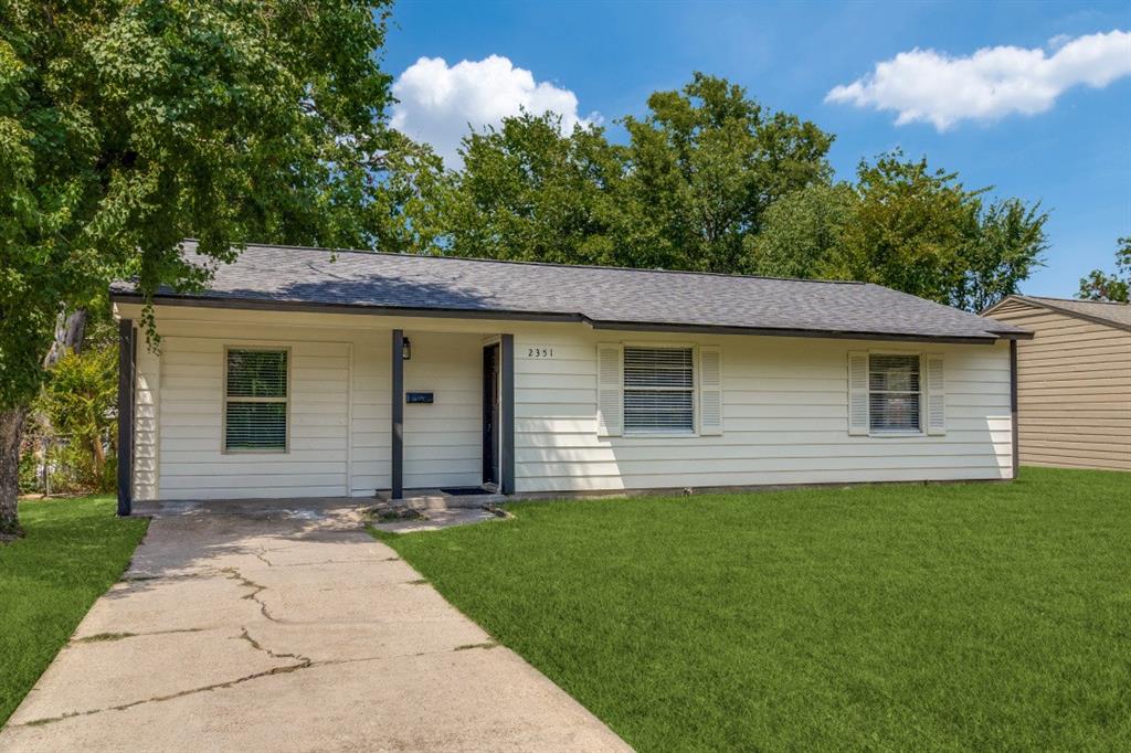 Single story home featuring a front lawn