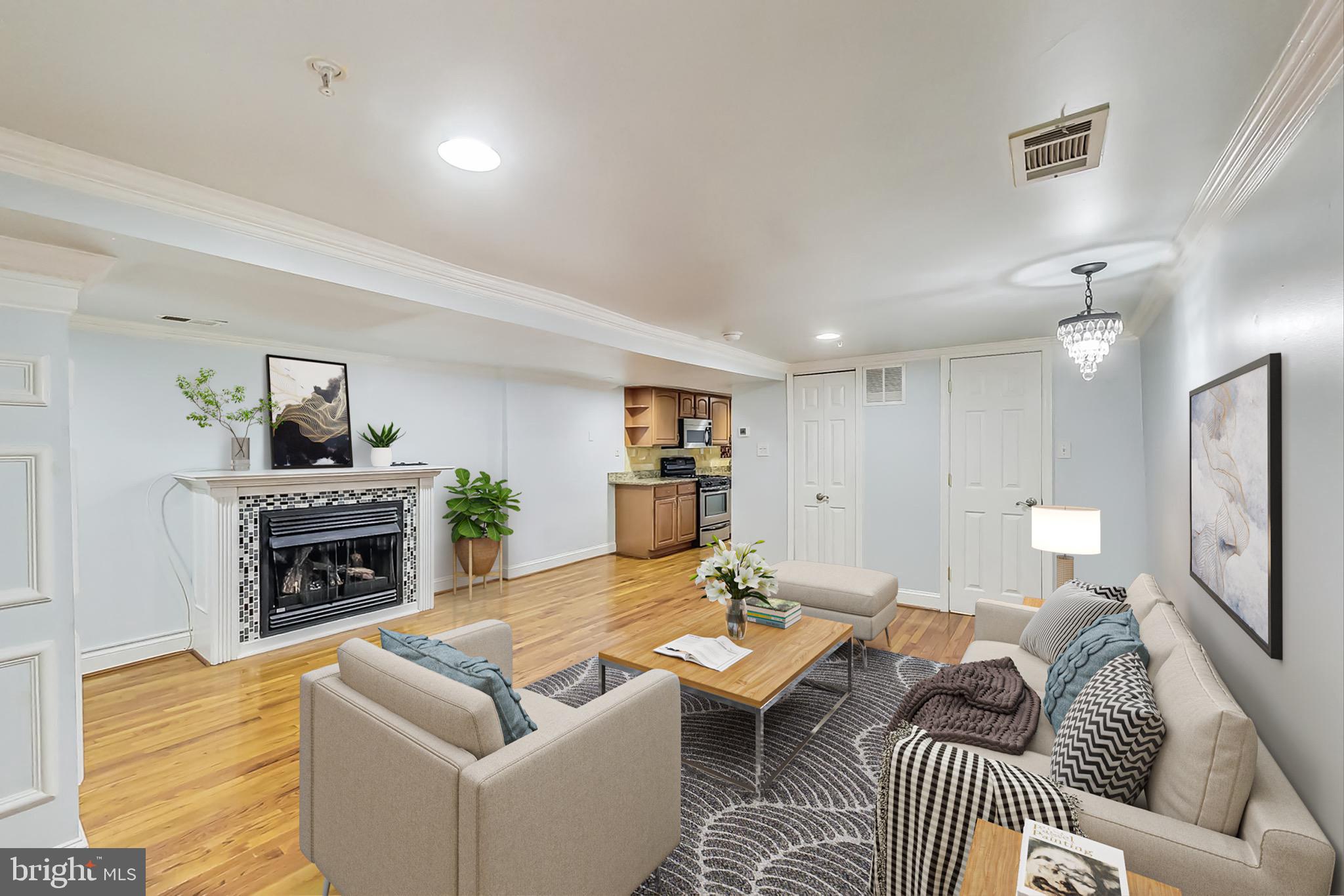 a living room with furniture and a fireplace