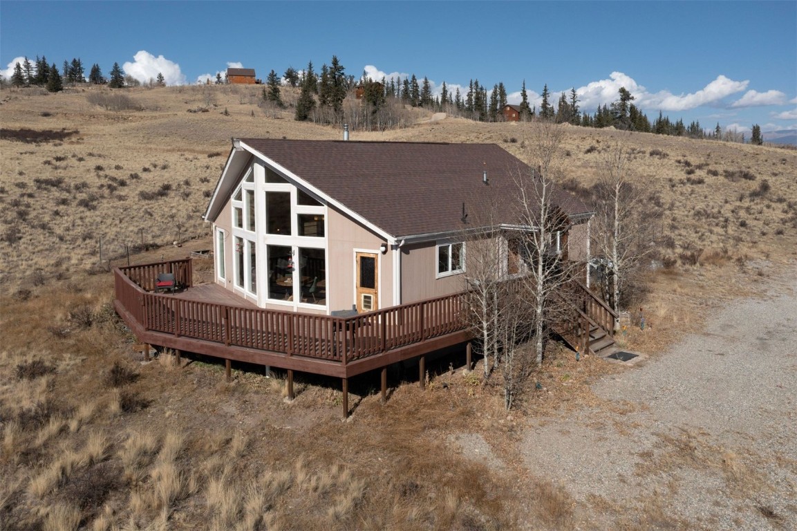 a view of a house with a wooden deck