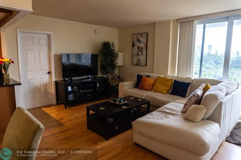 a living room with furniture and a flat screen tv