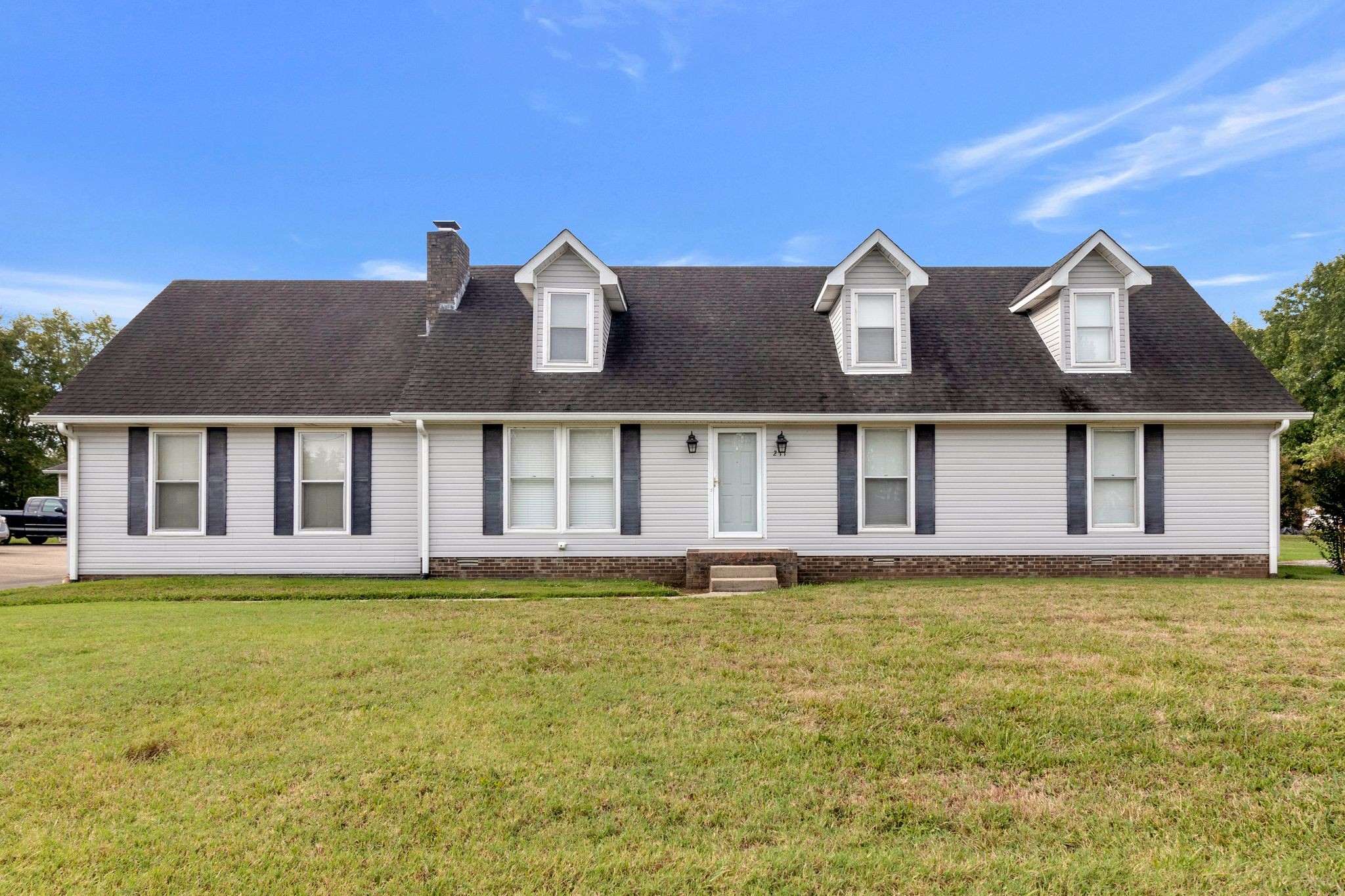 a front view of a house with a yard