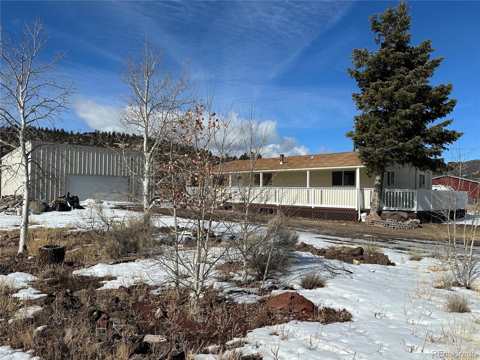 a front view of a house with a yard covered with snow