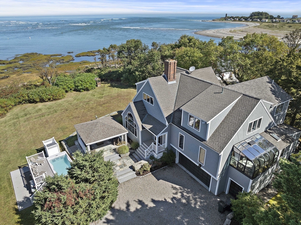 an aerial view of a house with a yard and lake view