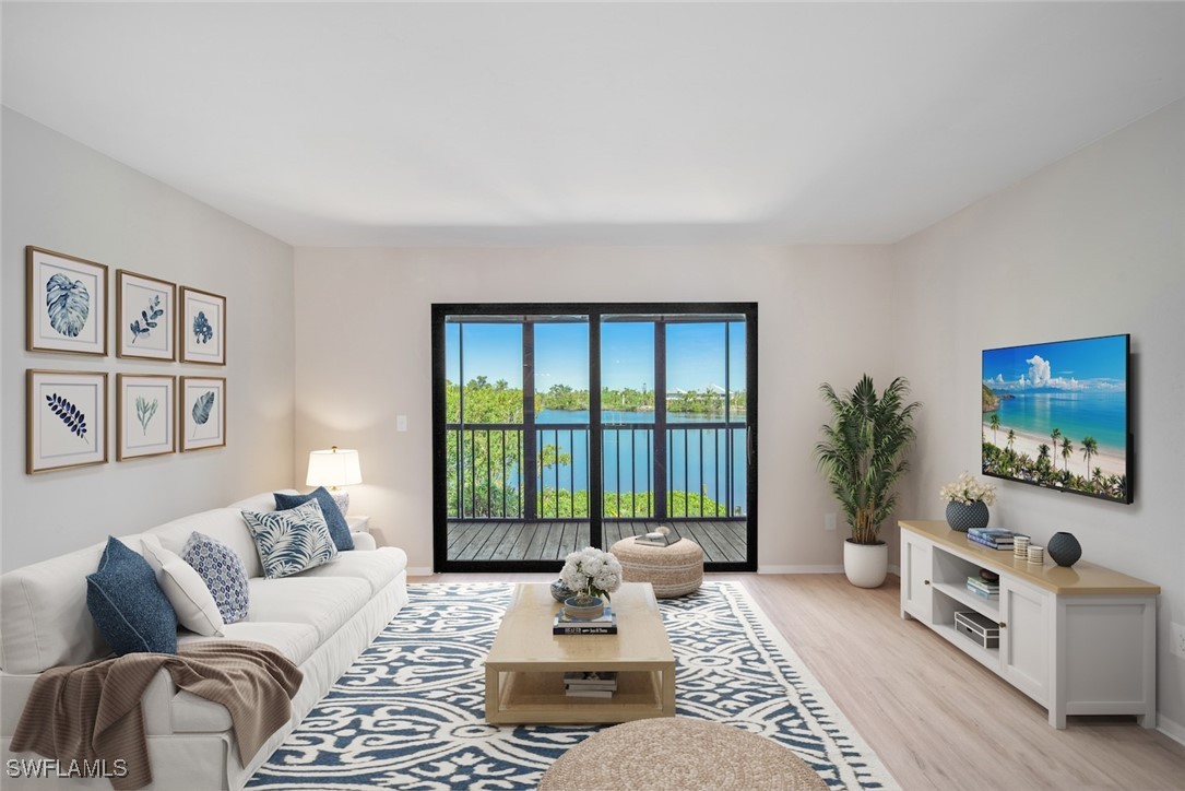 a living room with furniture large window and flat screen tv