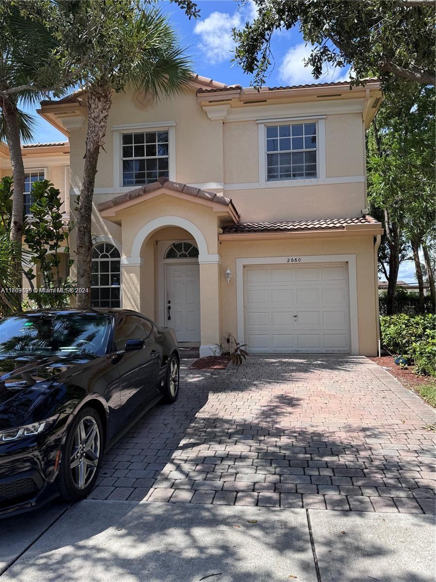 a front view of a house with parking space