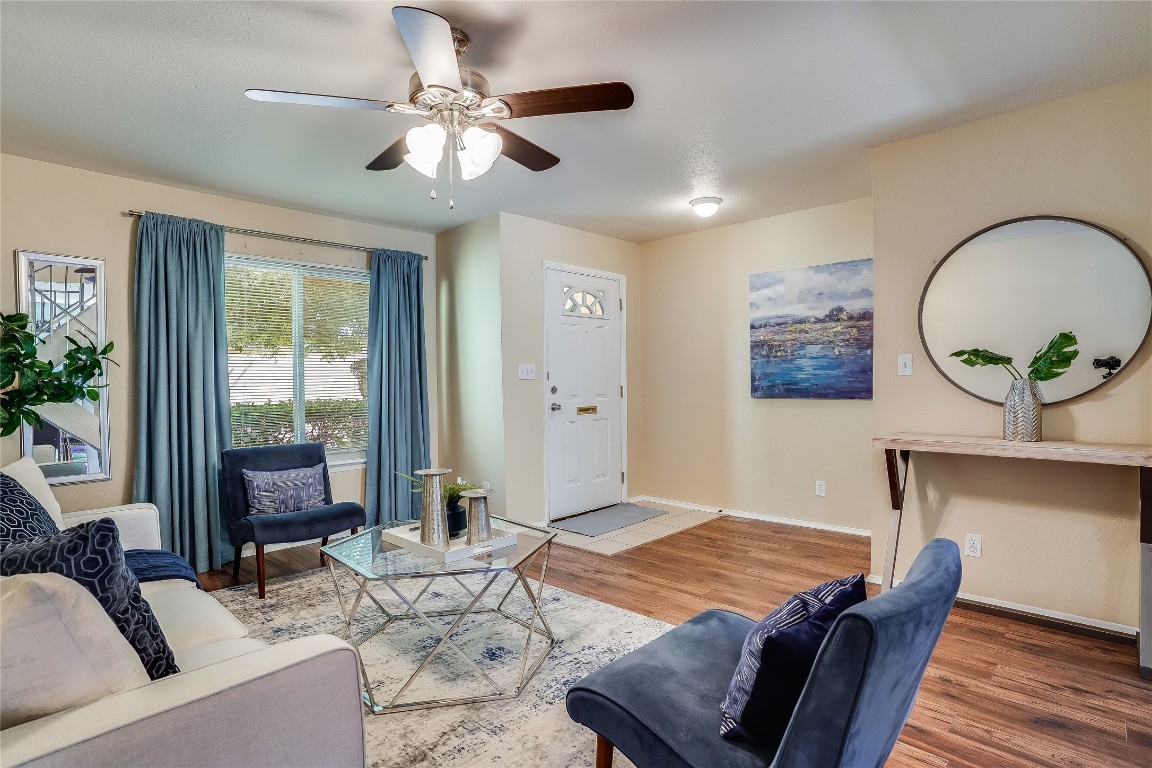 a living room with furniture and wooden floor