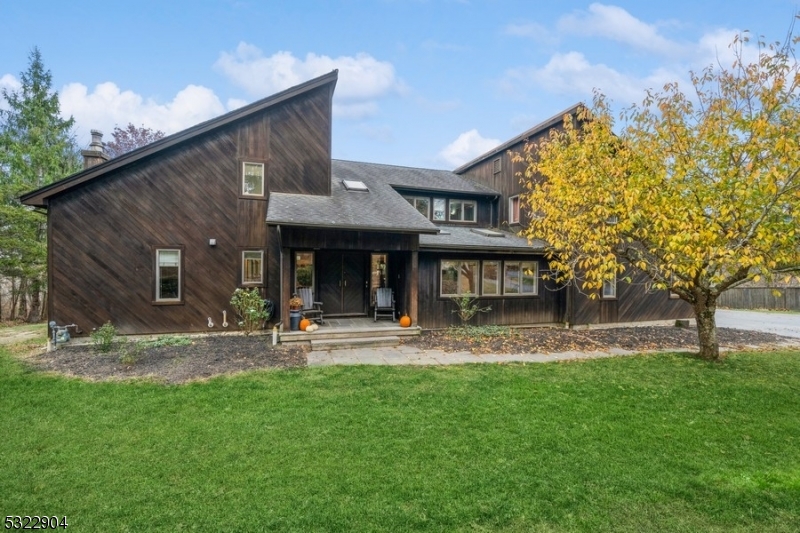 a view of a house with a yard and sitting area